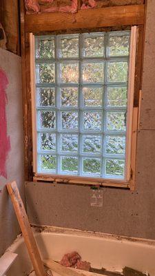 Progress photo of privacy window installation for a shower