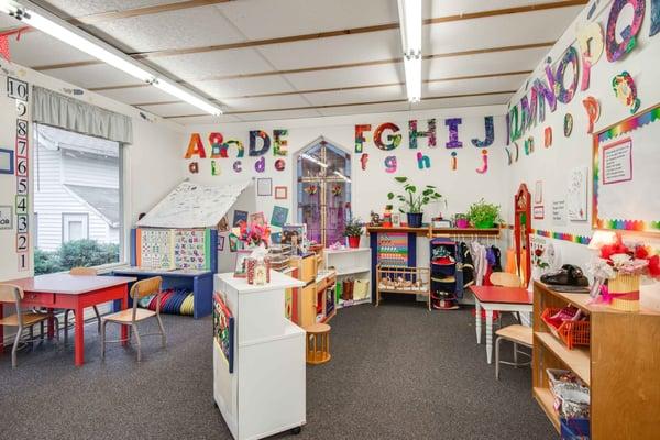 The main classroom where kids enjoy open play with arts and crafts, playdough, dress up, fine motor control activities.