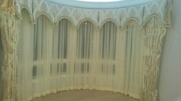 Circular valance over sheers and motorized drapes