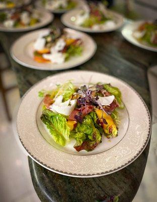 Little gem starter salad with ricotta salata, peaches, micro radish, and red wine-shallot vinaigrette.