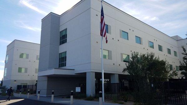 Entrance is left of the flagpole.