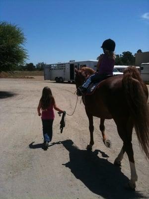 Sisters walking back to barn after lesson walking GiGi