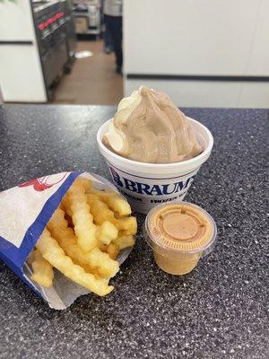 Small frozen yogurt swirl in a cup and a small fry