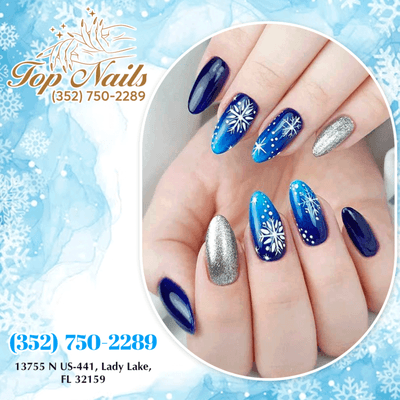 Dazzle in winter enchantment with elegant blue nail art adorned with delicate snowflakes, adding a touch of festive magic to your Christmas