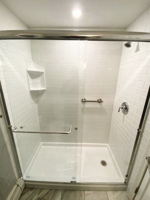 This beautiful walk-in shower was installed in one day as promised! we also installed a ceiling light for our lovely client.