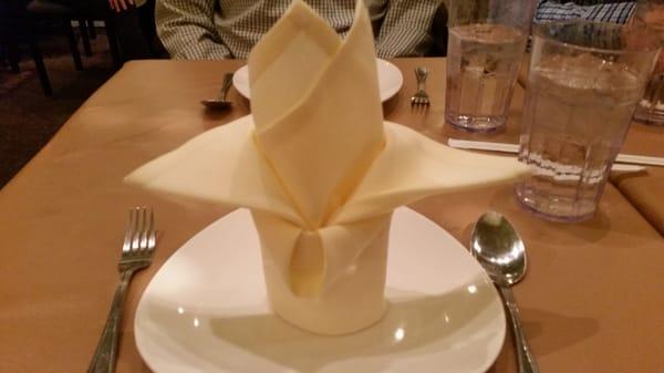 Napkin folding. Our waitress said it folded to look like a bird.