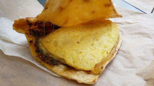 Interior of Just Egg roasted tomato and pesto flatbread ($7), vegan by default. Not bad. Hearty but a tad oily.