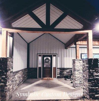 Cultured stone installation on wainscoting and slightly raised piers to offset the house stone