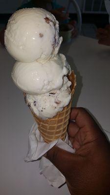 Butter pecan, rum raisin, and cookies n cream on a waffle cone.