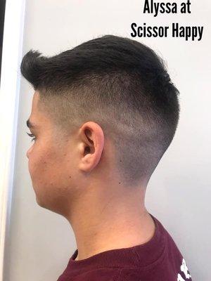 A tight skin fade by Alyssa. All of our stylists are able to provide all types of fades.