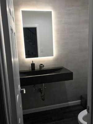 Powder Room Renovation with Floating Stone Sink, Waterfall Faucet, Large Format Tile Accent Wall, LED Backlit Mirror and Bidet Toilet