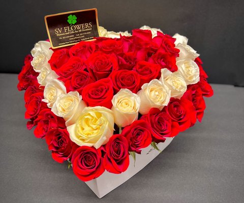 Heart box arrangement with white and red roses.