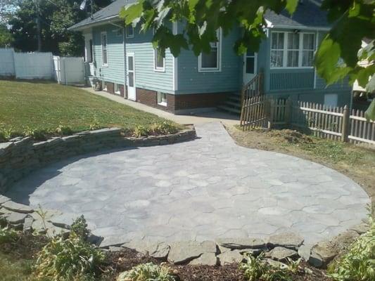 Stone wall and brick paver patio.