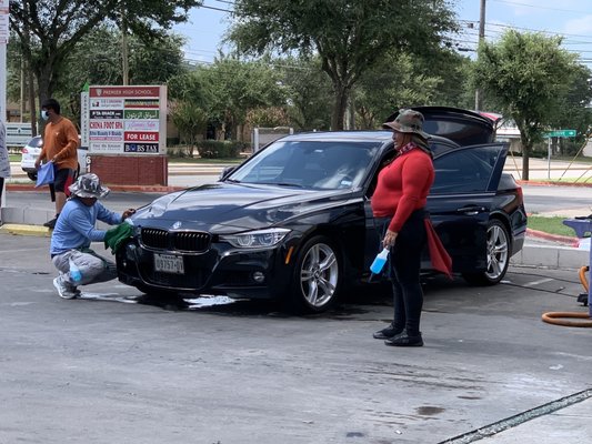 Making sure to rid bugs in the front of car.