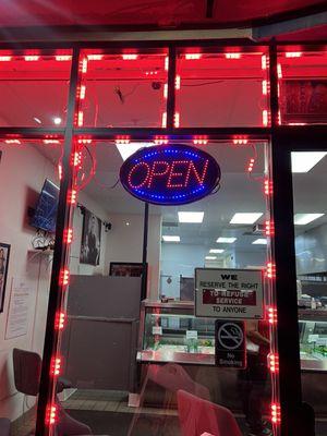 The very well lit neon sign that states open is the gentleman told me we're closed