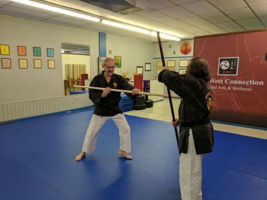 Two of our kobudo (weapons) students practicing with bo (6' staff)