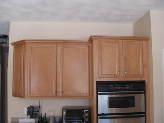 Before photo of kitchen cabinets featuring back lit accent design and installation.