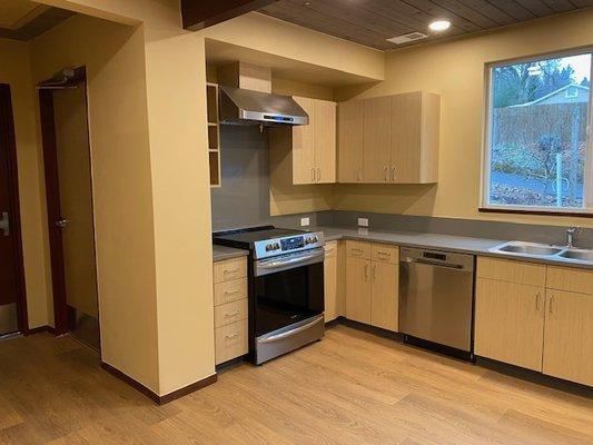 Cooking range plus another oven. Cabinets contain reusable plates, cups, serving dishes and utensils for guest use.