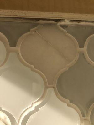 Installs cracked back splash telling me this is normal because its a glass material.