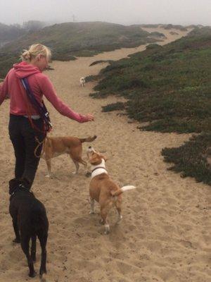 She gives treats to all her canine friends! They listen for their names, one by one.