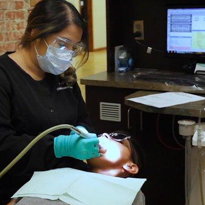 Dental Hygienist working on patient