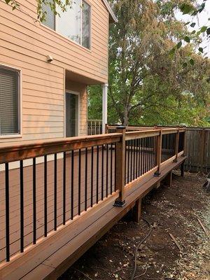 Installed new cedar decking and railings. Painted exterior. Semi transparent stain in Riverwood. After photo