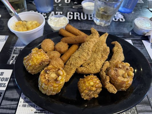 Fried catfish, fried corn on the cob, mac and cheese, hush puppies, corn fritters, tartar sauce.