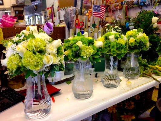 Apple green carnations, white roses, and green button mum bridal bouquets.