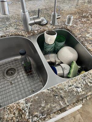 Dirty dishes left in sink.