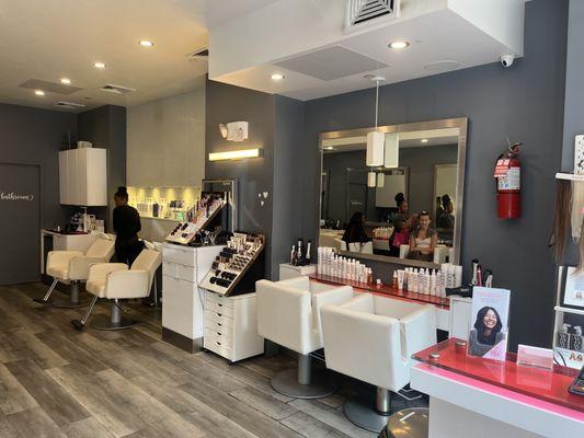 Our lovely little salon, you can see our blow dry stations, our wash stations and our signature pink accents!