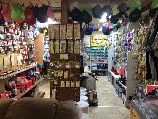 Little bait and tackle store with snacks, shirts and hats