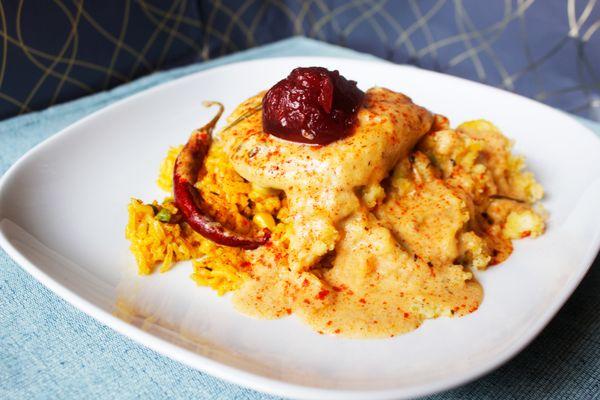 Pepper Jack Chicken served with savory bread-dressing, Persian Rice, and cranberry sauce