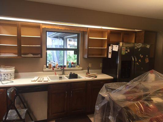 Kitchen remodel using the same cabinets sanding and painting them everything else was changed and cut up sink cabinet and added farm sink