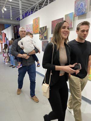 Families strolling through the gallery