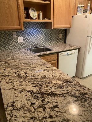 Slab and glass tile make a great combination for the kitchen,call today for an estimate