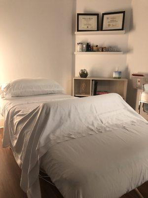 Treatment room with soft sheets and a full table heating pad