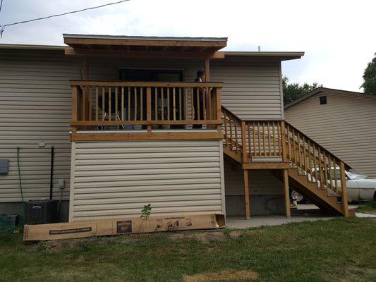 New pressure treated lumber with composite decking. Over hang and storage under deck. Vinyl to match house.