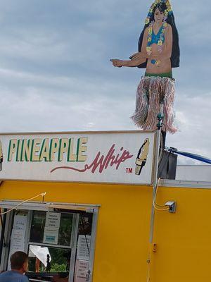 The food truck with a cutie pie moving hulu girl on top.