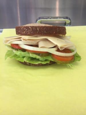 Whole Wheat Sandwich with turkey, cheese, onion, tomato, pickle, jalapeño, and lettuce