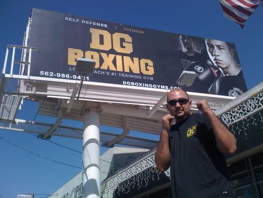 DG in front of his billboard