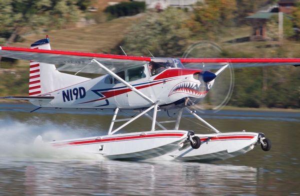 Shark Aviation's Cessna 185 amphibious seaplane on the step.