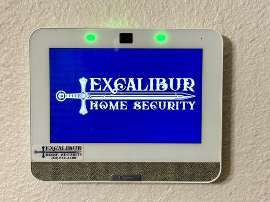 Excalibur logo displayed on Qolsys IQ4 touchscreen security panel.