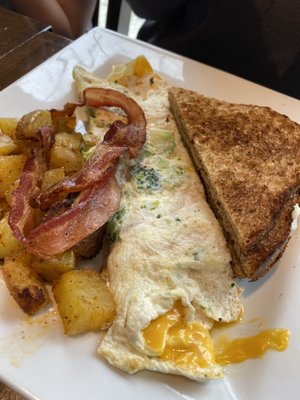 Egg white omelette, bacon, home fries and a side of whole wheat toast.