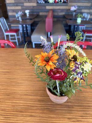 Artificial floral table settings.