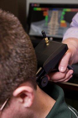 Dr. Yates performing a paraspinal muscle inflammation test using wireless Infrared sensors.