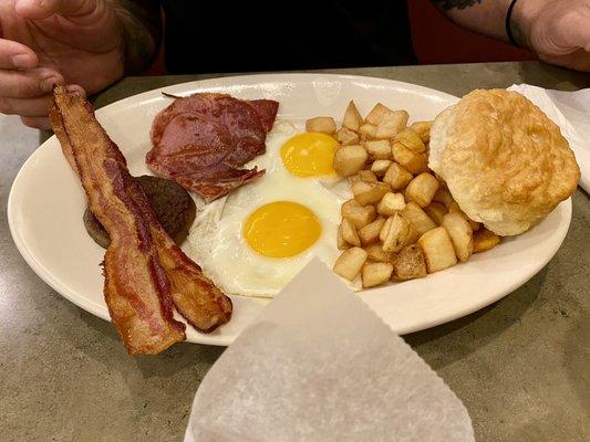 Breakfast sampler with over easy eggs, biscuit and hashbrowns