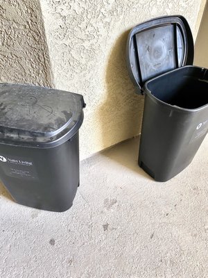 Trash cans outside front doors.