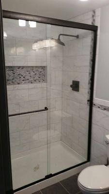 Semi Frameless bypass shower with matte black hardware