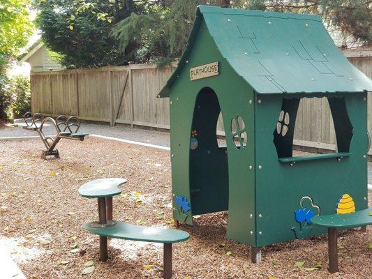 A playhouse and teeter totter