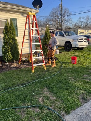 Pressure washing exterior of a house